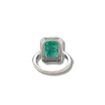 Emerald and diamond halo ring