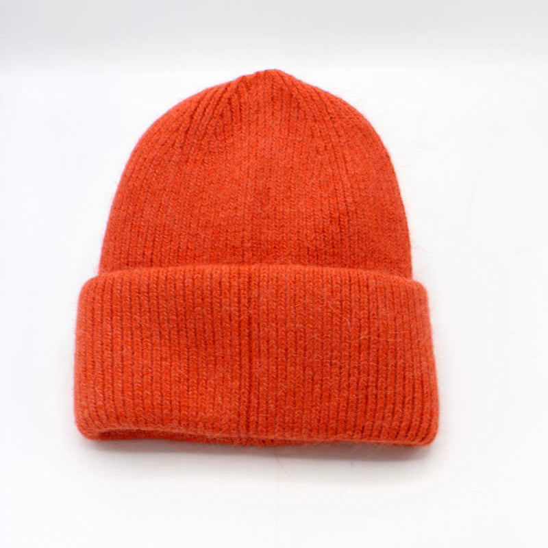 Orange knit beanie on a white background