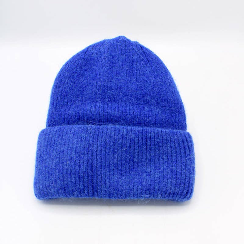 Blue knit beanie on a white background