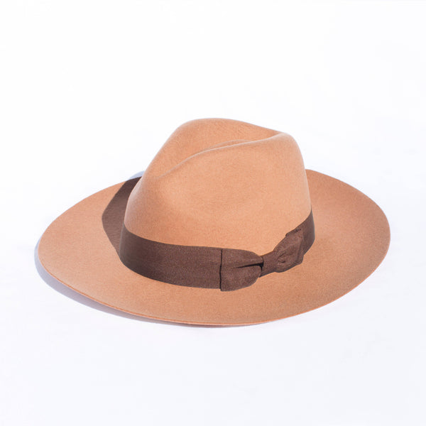 Tan fedora hat with a brown band on a white background