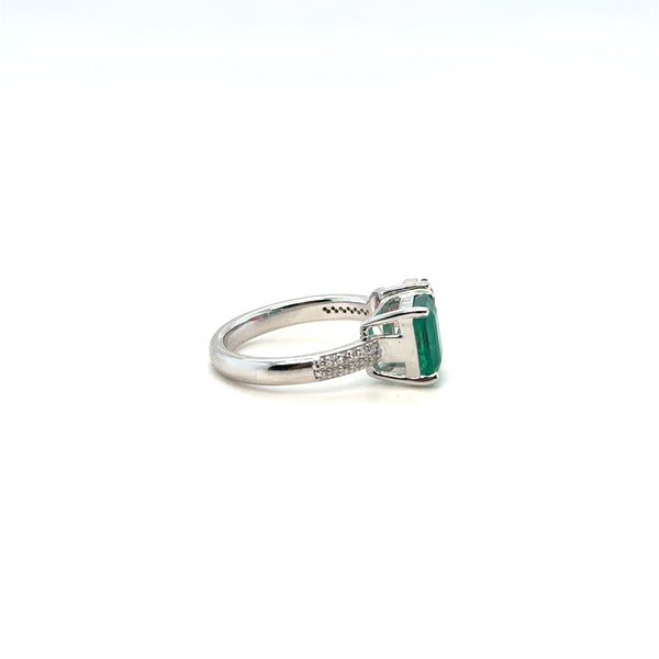 Emerald and diamond halo ring