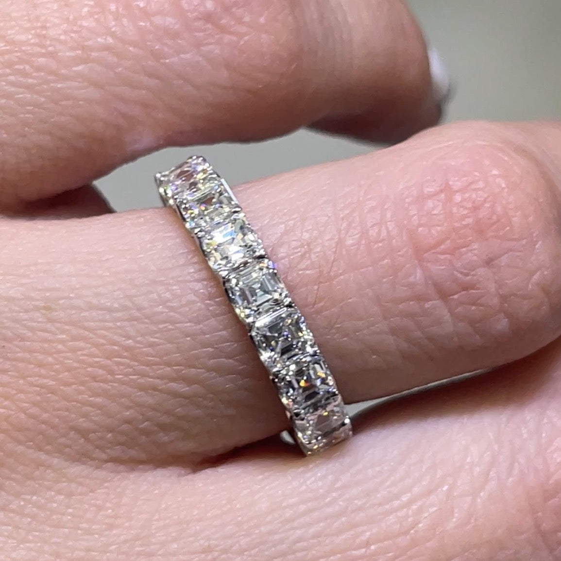 asscher cut band on the finger