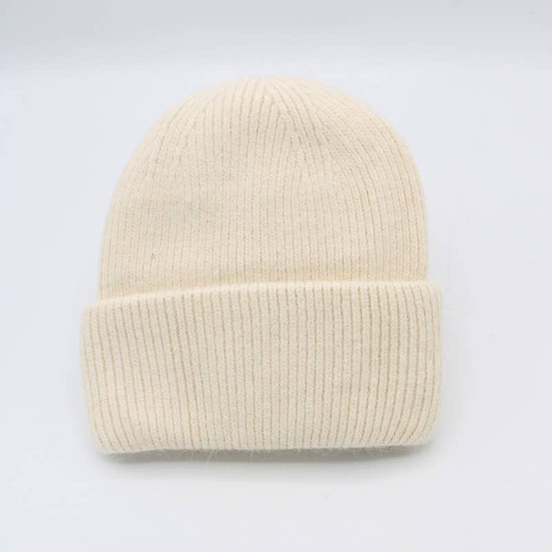 Beige knit beanie on a light gray background