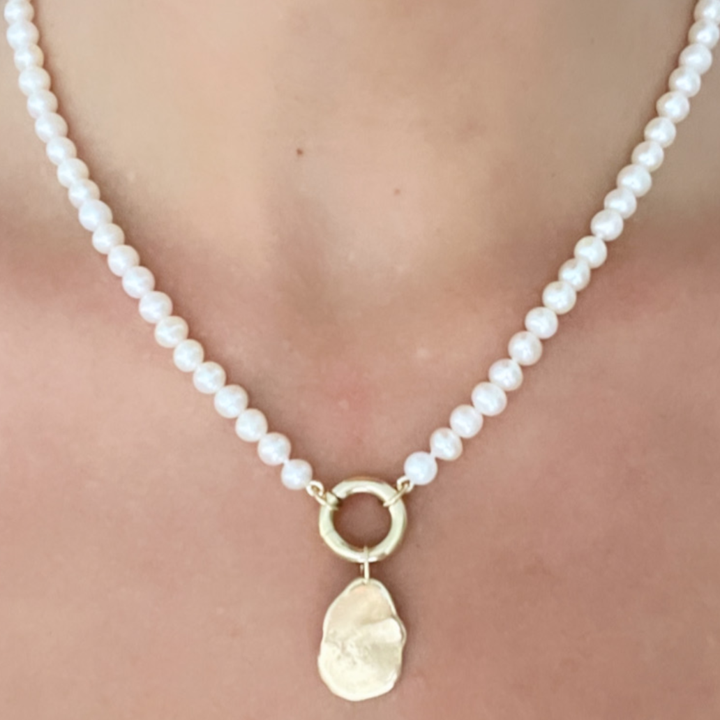 pearls on the neck with charm